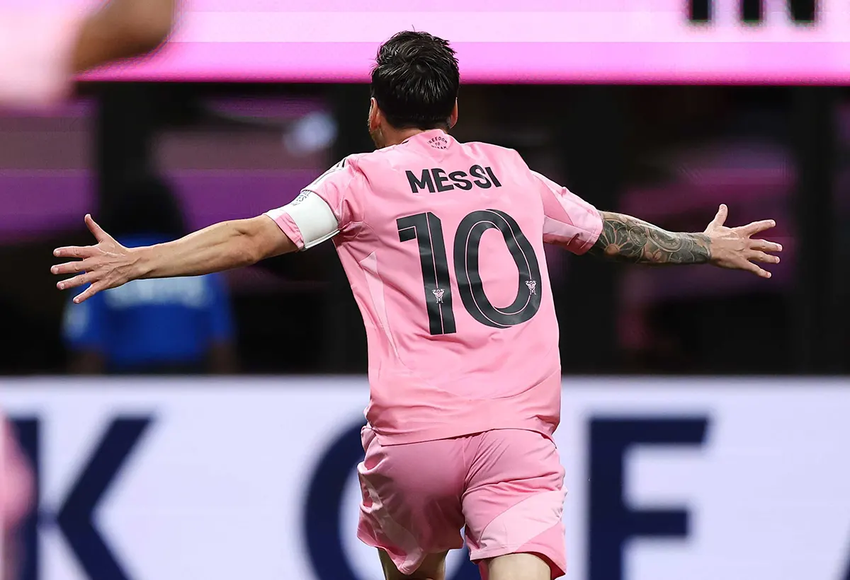 Lionel Messi in an Inter Miami pink jersey, back view, with "MESSI" and number "10" in the official font.