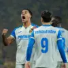 villarreal-cf-2026-2027 jersey Villarreal CF players celebrating on pitch wearing kit with cyan blue font nameplate mikautadze and number 9